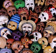 many different colored masks with faces on them