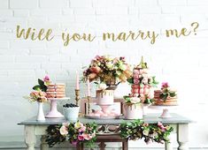 a table topped with cakes and flowers next to a sign that says class of 2019