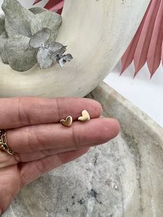 Our charming 14k gold-filled mini heart studs are perfect for daily wear. With their smooth and shiny finish, these charming and timeless earrings are a great fit for both adults and kids. We use 14k gold-filled high quality metal manufactured in the US.  All of the jewelry is handmade in my little California studio. Gold Earrings Studs Daily Wear, Timeless Earrings, Heart Stud Earrings, Earrings Studs, Tiny Heart, Mini Heart, Heart Studs, Heart Earrings Studs, Gold Earrings Studs