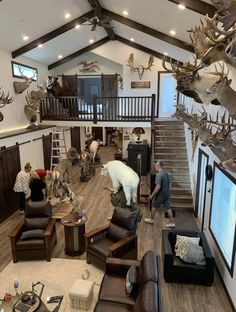 a living room filled with lots of furniture and antlers