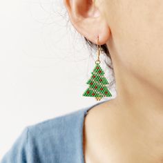 Add a touch of festive flair to your holiday wardrobe with these stunning Beaded Christmas Tree Earrings. Handcrafted with colorful seed beads, these drop earrings are a unique and meaningful present for your mom, sister, or friends. Perfect for adding a pop of holiday spirit to any outfit, these earrings are sure to become a favorite accessory during the Christmas season. Give the gift of style and cheer with these one-of-a-kind earrings. Size: 28X21mm Material: Miyuki Dedica beads Beaded Jewelry For Christmas Holiday, Christmas Gift Beaded Drop Earrings, Beaded Jewelry For Christmas Celebrations, Holiday Handmade Beaded Earrings Gift, Handmade Beaded Earrings For Holiday Gifts, Christmas Beaded Earrings As Gift, Christmas Festive Beaded Dangling Earrings, Handmade Beaded Earrings For Christmas Holiday, Handmade Beaded Earrings For Christmas