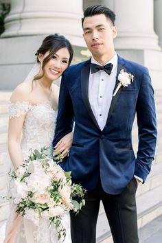 a bride and groom standing in front of a building