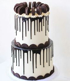 a white and black cake with chocolate cookies on top