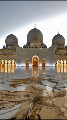 the inside of a building with many arches and domes on it's sides, all lit up at night