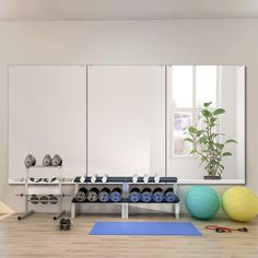 a room with exercise equipment and yoga mats