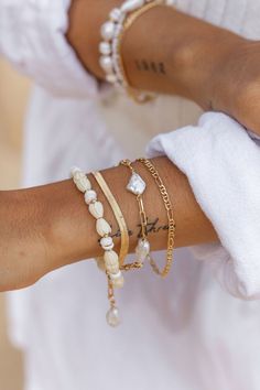 "Flanked with natural white puka shells and pikake flowers, this unique shell bracelet evokes visions of Hawaii's white sands and soothing shores. Stack this gold bracelet with other beaded beauties and you'll be ready for your tropical escape. ✦ DETAILS ✦ ✧ Name: Me'e (MAY aye) - Heroine. ✧ Adjustable from 6.5\"-8\". ✧ 6-7mm White Puka Shells. ✧ Carved Resin Pikake Flowers. ✧ 14kt Gold Filled with lobster clasp. ✧ All Ke Aloha Jewelry pieces come packaged thoughtfully, beautifully, and ready fo White Shell Pearl Bracelet For The Beach, White Shell Pearl Bracelet For Beach, Elegant White Bracelets For Vacation, White Oyster Bracelet Jewelry For The Beach, White Oyster Bracelet Jewelry For Vacation, White Shell Oyster Bracelet, White Shell Bracelets As A Gift, White Shell Bracelets Perfect For Gifts, White Bohemian Jewelry With Oyster Bracelet