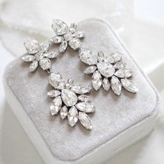 Add a touch of glamour to your bridal look with these luxurious Austrian Crystal Statement Wedding Earrings. Expertly crafted with gleaming and spatkly Swarovski crystals, these timeless earrings will enhance any bridal ensemble. An elegant choice for a truly memorable day.Earrings dangle 3-1/4 inches and are 1-3/8 inch at their widest. PLEASE ALLOW APPROX 10 BUSINESS DAYS FOR COMPLETION BEFORE SHIPPING.Link to videohttps://www.instagram.com/p/B3XSDasDjTW/?igshid=1p6hsj0jvjjbp Statement Wedding Earrings, Timeless Earrings, Statement Earrings Wedding, Bridal Statement Earrings, Bridal Look, Austrian Crystal, Earrings Dangle, Bridal Looks, Wedding Earrings