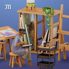 a man sitting at a table with an easel and painting