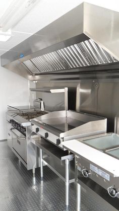 an industrial kitchen with stainless steel appliances and counters