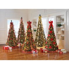 three christmas trees decorated with red bows and ribbons, all in the same color scheme