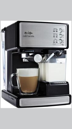 a coffee maker with a cup of coffee on the side and milk in front of it