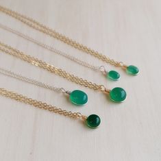 "Minimalist gemstone necklace featuring a natural Green Onyx. Each pendant is handmade from delicate wire securely wrapping the stone. You can coose between sterling silver or 14k gold filled wire. The pendant is suspended of a 14k gold filled or sterling silver chain. You can choose the material and your favourite gemstone from the drop down menu! Please insert the desired necklace length in the \"personalization\" box. STONE SHAPES: - oval shaped - round shaped - drop shaped STONE SIZES: - XS Delicate Green Sterling Silver Necklaces, Delicate Green Sterling Silver Necklace, Handmade Gold Necklaces With Green Onyx, Handmade Gold Green Onyx Necklaces, Dainty Green Gemstone Charm Necklace, Handmade Green Onyx Gold Necklace, Handmade Dainty Emerald Necklaces, Dainty Handmade Necklaces For May Birthstone, Dainty Handmade May Birthstone Necklaces