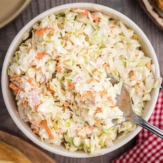 a white bowl filled with coleslaw and carrots