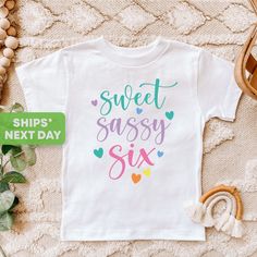 a t - shirt that says sweet sassy six on it next to some other items