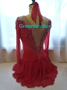 the back of a red dress with beadings and ruffles on it