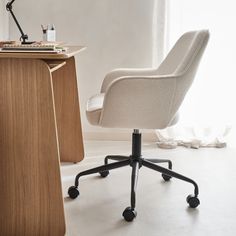 an office chair next to a desk with a computer on it