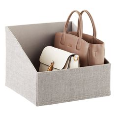 three purses in a box on a white background, one is beige and the other is brown