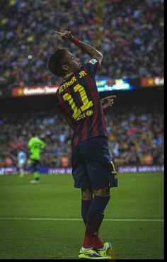 a soccer player is in the air with his hand up to his head as he celebrates