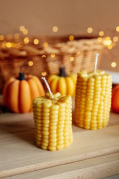 corn on the cob candles with pumpkins in the background