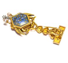 Art Nouveau Pendant Lapel Watch Step into a world where time is adorned with artistry and elegance. This exquisite pendant lapel watch from the Art Nouveau era is a masterful fusion of craftsmanship and opulence. Crafted in 18K gold, the watch features a delicate interplay of diamond accents, rich enamel, and lustrous pearls, all meticulously arranged to create a captivating design. The intricate enamel work showcases the fluid, organic lines characteristic of the Art Nouveau movement, while the Luxury Collectible Watches, Luxury Yellow Gold Collectible Watch, Luxury Yellow Gold Pendant Brooch, Luxury Collectible Quartz Jewelry And Watches, Luxury Gold Collectible Jewelry And Watches, Luxury Gold Jewelry And Watches Collectible, Formal Gold Locket Brooches, Timeless Jewelry Brooch As Gift, Timeless Jewelry Brooch For Gift