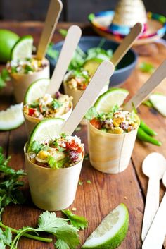 small cups filled with food sitting on top of a wooden table