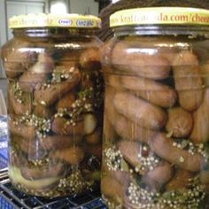 two large jars filled with food sitting on top of a counter next to each other