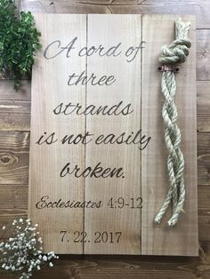 a wooden sign with a rope attached to it and the words, a lord of three strands is not easily taken