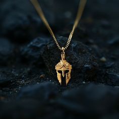 Channel the warrior spirit with our gold Spartan helmet pendant, meticulously crafted in the USA. Symbolizing strength, honor, and valor, these pieces are designed for those who embody the fearless spirit of a Spartan. PENDANT INFORMATIONThis pendant is made of real, solid gold.• Made in USA• Material: 14k or 18k solid gold• Finish: polished• Height: 1.5" (38 mm) | *includes the small circle, bail dimensions not included• Width: 0.8" (19,5 mm)• Pendant weight: approx. 6 grams (14k)• Bail: fits u Warrior Style Gold Necklaces As Gift, Warrior Style Engraved Pendant Jewelry, Engraved Warrior Style Pendant Jewelry, Warrior Helmet, Phoenix Pendant, Spartan Helmet, Inner Warrior, Historical Jewellery, Warrior Spirit