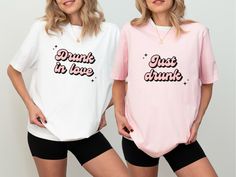 two women wearing pink and white shirts with the words drunk in love printed on them