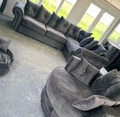 a living room filled with lots of gray furniture