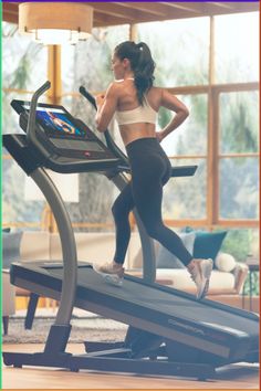 a woman is running on a treadmill