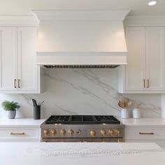 a stove top oven sitting inside of a kitchen next to white cupboards and counter tops