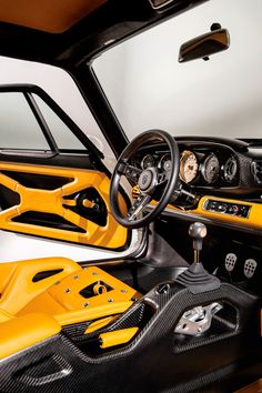 the interior of a yellow sports car