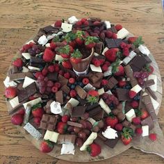 a platter filled with chocolate, strawberries and cheese