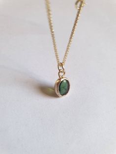 This minimalist Green Tourmaline, solid gold necklace was designed with a bottle green see through pendant, to beautifully accompany you through your busy days. The classic simple design is always pretty for day and evening, work or fun. The gold Tourmaline necklace is handmade and delicate and available both with a 9kt or a 14 karat pendant. The solid gold chain is made of 14k and available in a of couple lengths. The clear Green Tourmaline necklace is a perfect chic and elegant gift. The penda Minimalist Gold Emerald Necklace As Gift, Delicate Green Necklace For Everyday Wear, Gold Emerald Birthstone Necklace In Minimalist Style, Minimalist Green Necklace For May Birthstone, Minimalist Emerald Necklace As Gift, Minimalist Emerald Necklace For Gift, Dainty Green Birthstone Necklace For Everyday, Minimalist Yellow Gold Emerald Necklace For Gift, Minimalist 14k Gold Charm Necklace With May Birthstone