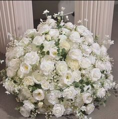 a bouquet of white flowers sitting on top of a table