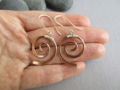 "Forever popular spiral earrings with a modern twist for everyday use. I created these earrings to have a nice neutral, casual, lightweight jewelry which is a little bit unusual since I like very much the unusual The copper wire was hand forged and hammered to get spiral shape which is decorated with a silver wire wrap on the top part. The wrap has a loop so the ear wire can be attached to it. I made the ear wire long to give a modern touch to the design. For the ear wire I used Sterling Silver Copper Wire Earrings, Wire Wrapped Jewelry Diy, Mixed Metal Earrings, Light Weight Jewelry, Wrap Earrings, Wire Jewelry Designs, Spiral Shape, Hammered Earrings, Wrapped Earrings