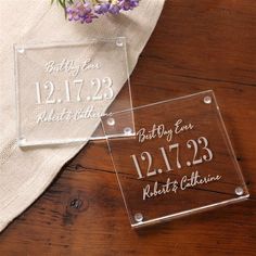 two personalized acrylic blocks sitting on top of a table next to flowers