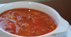 a white bowl filled with soup on top of a table