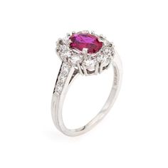 This is part of Chairish’s Fine Jewelry assortment.  Vintage Tiffany & Co ruby & diamond cluster ring crafted in 900 platinum (circa 1960s).    Oval mixed cut natural ruby measures 7.1 x 5.4 x 3.0mm (estimated at 1 carat). Color and inclusions are typical of rubies from Burma (Myanmar). There is no evidence of any treatments to the ruby. Sixteen diamonds total an estimated 0.70 carats (estimated at F-G color and VS clarity). The ruby is in good condition with two tiny chips evident (visible unde Luxury Ruby Cluster Ring With Center Stone, Luxury Cluster Ruby Ring With Center Stone, Elegant Platinum Ruby Ring With Halo Setting, Elegant Ruby Ring With Halo Setting In Platinum, Cluster Ruby Diamond Ring With Center Stone, Formal Ruby Ring With Halo Design, Oval Ruby Ring With Platinum Center Stone, Oval Ruby Ring With Platinum Band, Oval Ruby Ring With Platinum Setting