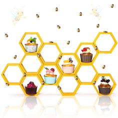 a honeycomb with cupcakes on it and some bees flying around the area