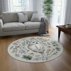 a living room with a white couch and an owl rug