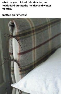 a bed with a plaid headboard and white pillows