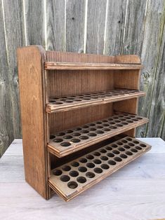 an old wooden shelf with holes in it