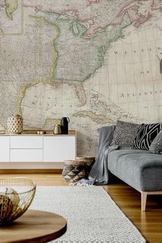 a living room filled with furniture and a large map on the wall