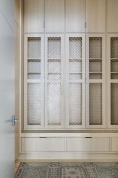 an empty room with wooden cabinets and rug