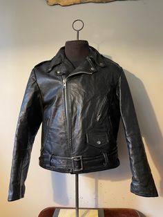 "Vintage Leather Jacket  - Biker style - 1960s vintage  - Buckle strap bottom belt  - Flared zipper sleeves  - Zipper/button pockets  - Buttoned Collar - Rare vintage Grail - Cropped style design  - Clix zipper  Size: L/M 24\" pit to pit  26\" shoulder to waist  25\" sleeve  Great vintage condition  No rips or holes  No stains" Retro Leather Jacket With Zipper For Biker Events, Retro Biker Jacket With Zipper For Biker Events, Retro Winter Biker Jacket With Zipper Closure, Vintage Black Outerwear With Zipper Closure, Retro Fitted Outerwear With Zipper Closure, Vintage Leather Motorcycle Jacket With Long Sleeves, Vintage Leather Jacket With Zip Fly, Vintage Leather Jacket With Long Sleeves And Zip Fly, Vintage Leather Jacket With Long Sleeves