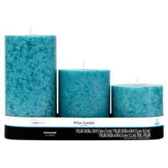 three teal pillar candles sitting on top of each other