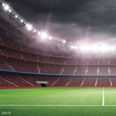 an empty soccer stadium with red seats and lights on the sidelines is pictured in this image