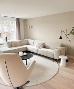 a living room filled with furniture and a large window